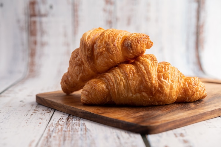 Круассаномат Tekno Stamap 2 croissants on a wooden cutting board 1150 28480